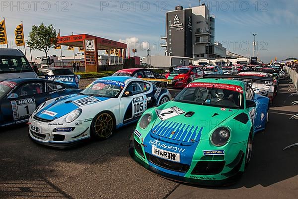 Racing car left Porsche Cayman R right 911 GT3 RSR in Parc Ferme