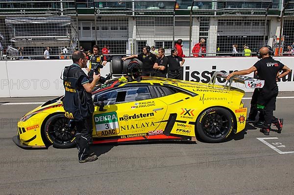 Lamborghini Huracan GT3 with racing team in front of start of car race