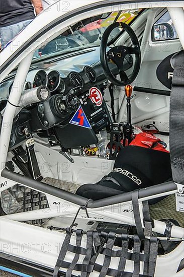 View inside cockpit of racing car Porsche Cayman R in grid lane in front of start of car race