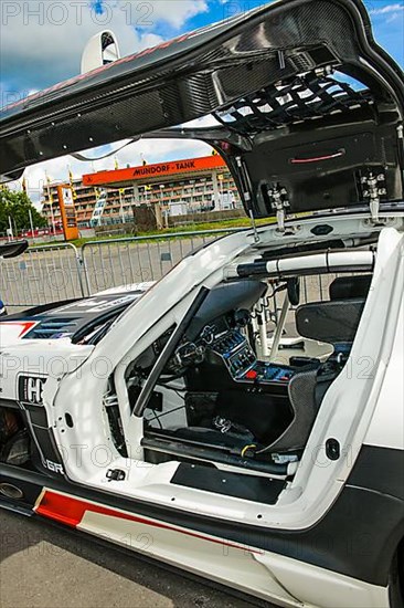 View into interior cockpit of racing car Mercedes-AMG GT3 with bucket seat centre console electronic controls