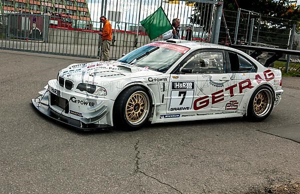 Race car BMW E46 V8 Kompressor sees green flag for exit on race track