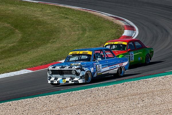 Historic race cars in front BMW 2002ti behind Ford Escort at car race for classic cars Youngtimer Classic Cars 24-hour race 24h race