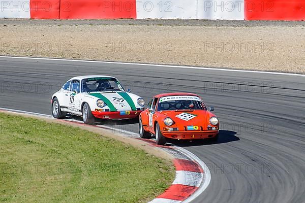 Two historic racing cars Porsche 911 close together in curve at car race for classic cars Youngtimer Classic Cars 24-hour race 24h race