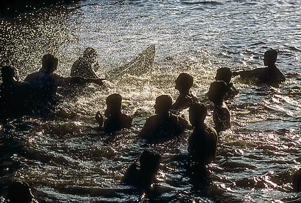 Audience playing with water during the Snake boat race at Payippad near Haripad