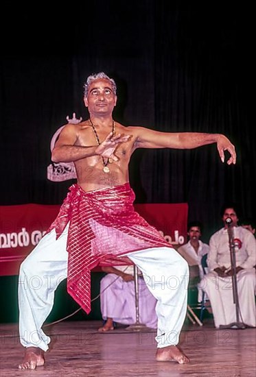 Kalamandalam Gopi demonstrating kathakali exercise in Kerala Kalamandalam