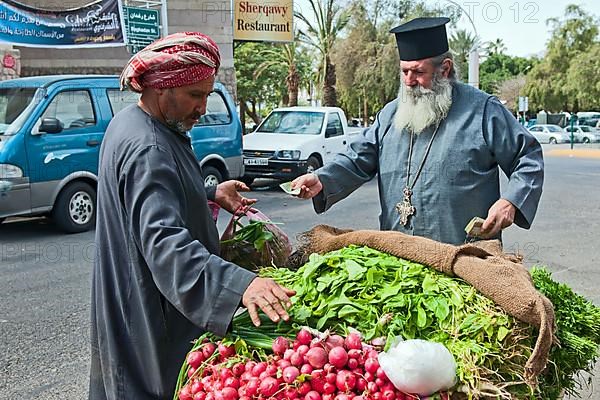 Vegetable vendor and Greek Orthodox priest