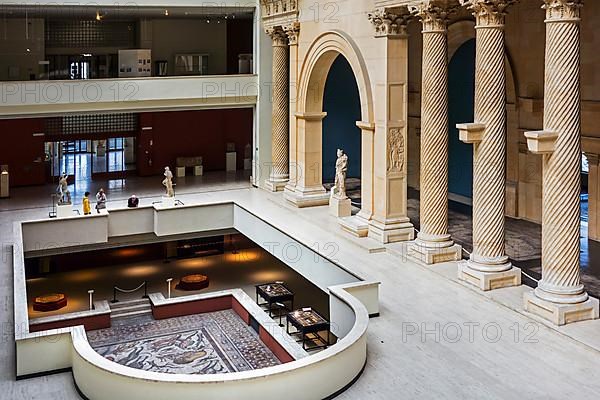 Visitors look at a Roman mosaic from Apamea