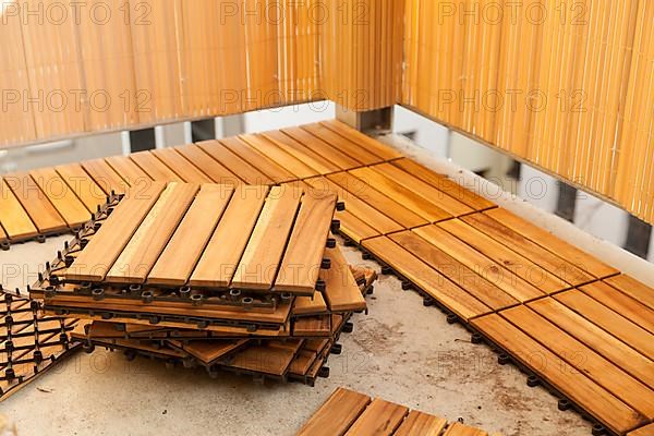 Laying of wooden patio tiles on balcony