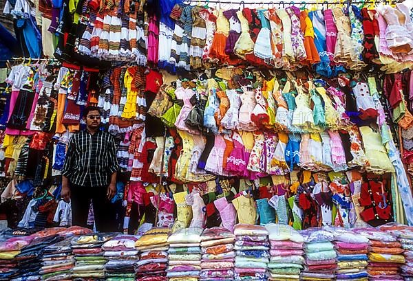 A man selling children dress on a plat form near City Market in Bengaluru Bangalore