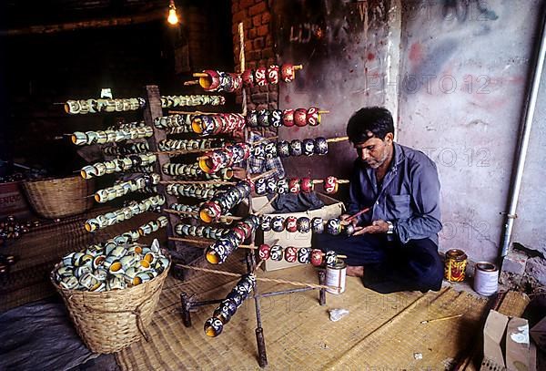 Painting a wooden toy at Channapatna a flourishing centre for lacquerware painted wooden toys near Bengaluru Bangalore