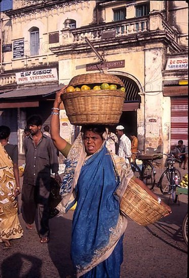 Lady struggling with heavy luggage