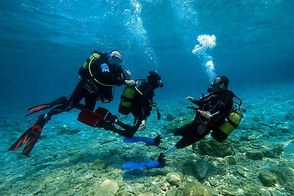 Disabled diver with instructor in sea