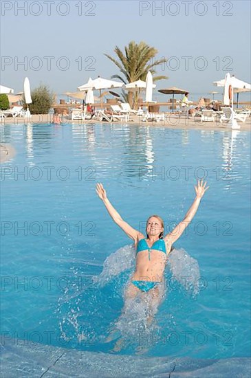 Young woman jumping backwards