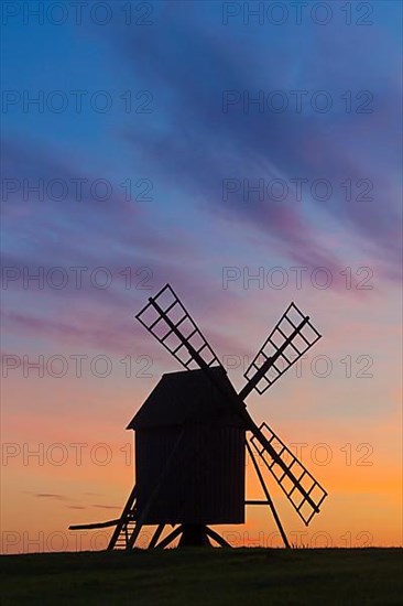 Traditional windmill at Resmo silhouetted against sunset on the island of Oeland