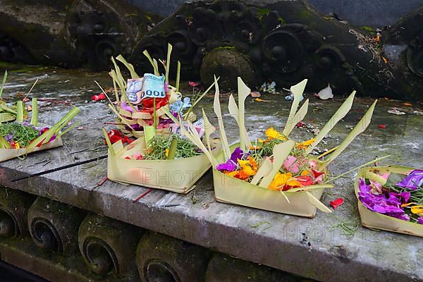 Offering baskets filled with money and flowers