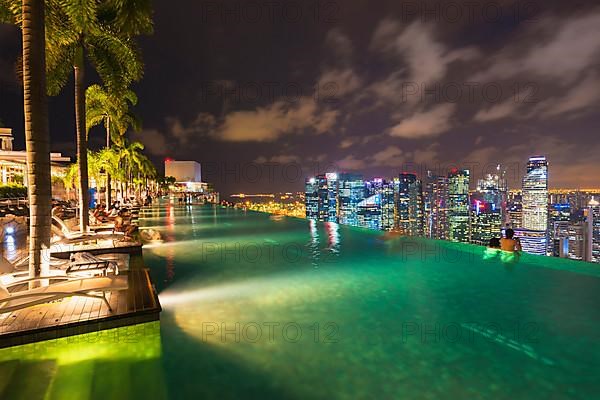 The city's central financial district at night as seen from the infinity pool of the Marina Bay Sands Hotel