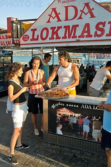 Women try sweet Turkish pastries at market