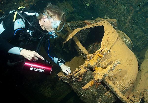 Diver looks into large dough machine in wreck Umbria