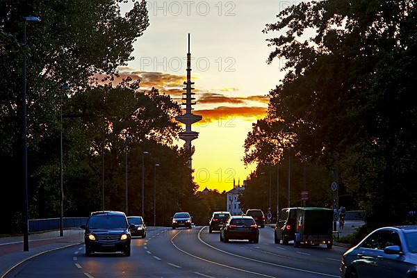 Cars on the Kennedy Bridge in front of the Heinrich Hertz Tower at sunset