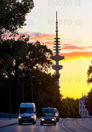 Cars on the Kennedy Bridge in front of the Heinrich Hertz Tower at sunset