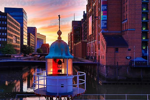 Former lighthouse in front of the International Maritime Museum Hamburg at sunrise