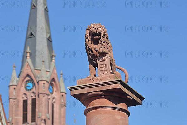 Market fountain with town coat of arms and steeple of the town church of St. Peter and Paul on the market square in Calw