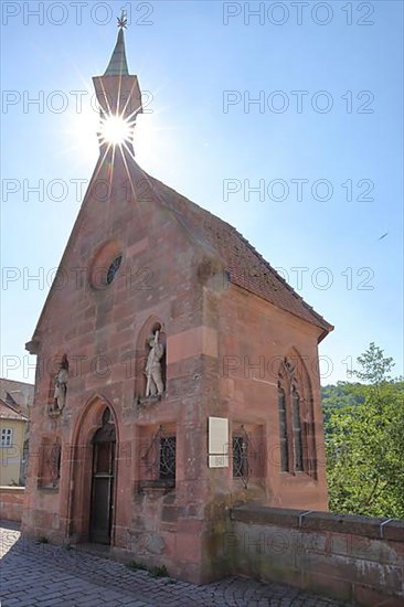 St. Nicholas Chapel built in 1400 at the St. Nicholas Bridge in the backlight of the sun in Calw