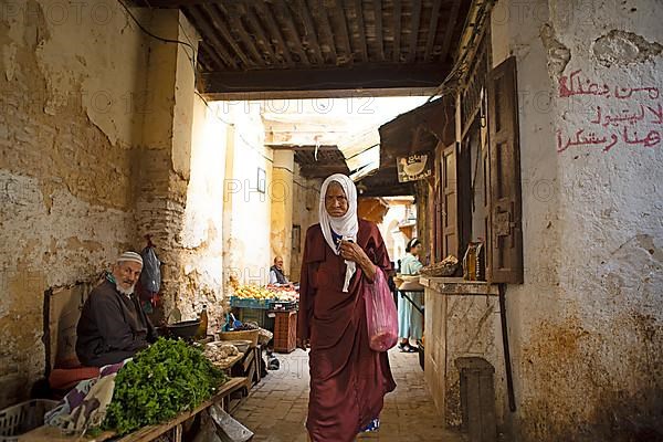 Old Moroccan woman in an old town alley