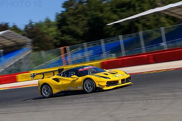 Racing car sports car Ferrari 488 Challenge speeds at full throttle at exit of corner hairpin La Source of racetrack