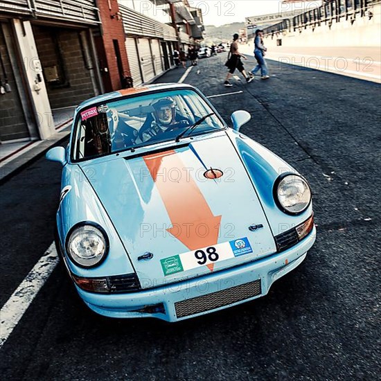 60s style shot of historic racing car sports car classic car Porsche 911 RS in pit lane Pit Lane of race track