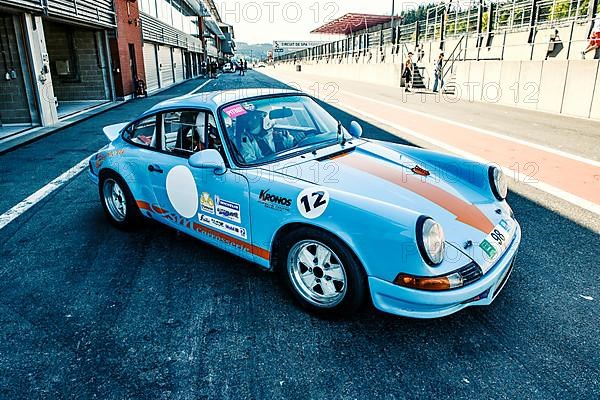60s style shot of historic racing car sports car classic car Porsche 911 RS in pit lane Pit Lane of race track