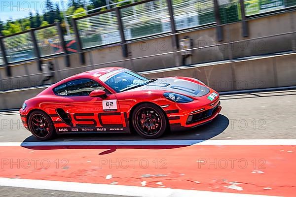 Sports car race car Porsche Cayman drives through pit lane Pit Lane of race track