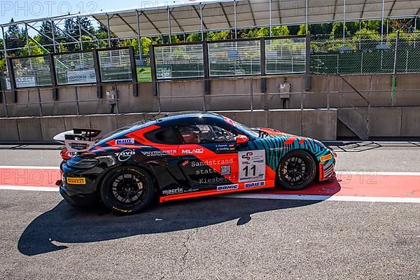 Racing car Porsche Cayman GT4 Clubsport MR drives through pit lane Pit Lane of race track