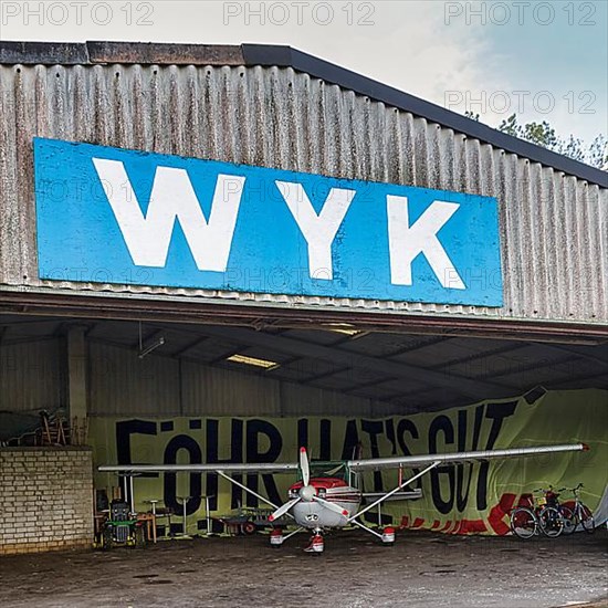 Light aircraft standing in hangar