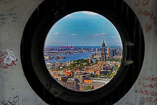 City view with the Michel and the harbour through the porthole windows in the spire of the main church St. Petri