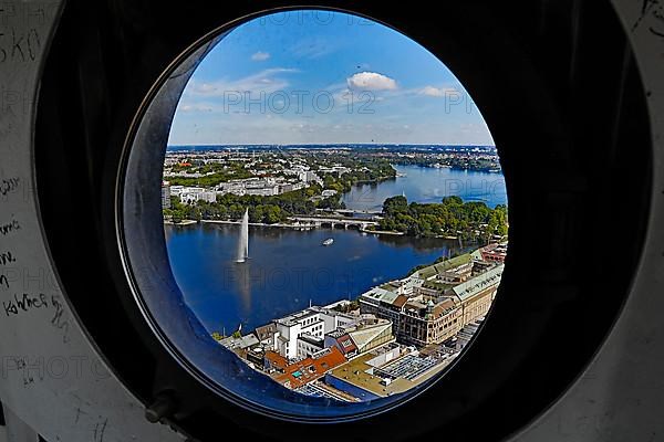 City view of the Inner Alster Lake through the porthole windows in the spire of the Hauptkirche St. Petri