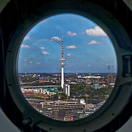 City view of the Heinrich Hertz Tower through the porthole windows in the spire of the main church of St. Petri