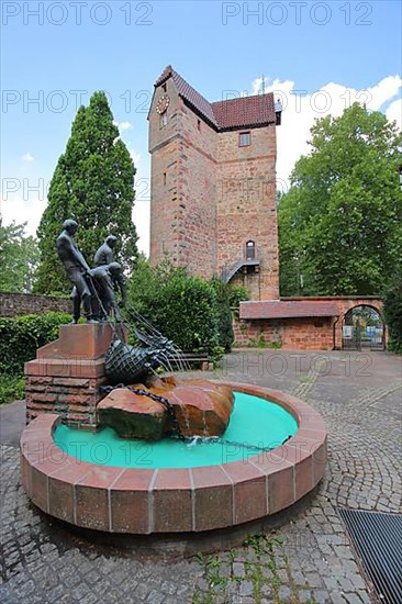 Fishermen's fountain with fishermen fishing and powder tower as landmark of Eberbach