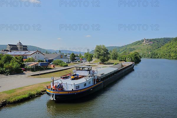 Cargo ship near Hassmersheim on the Neckar with the building of the Alte Maelzerei and a view of Horneck Castle