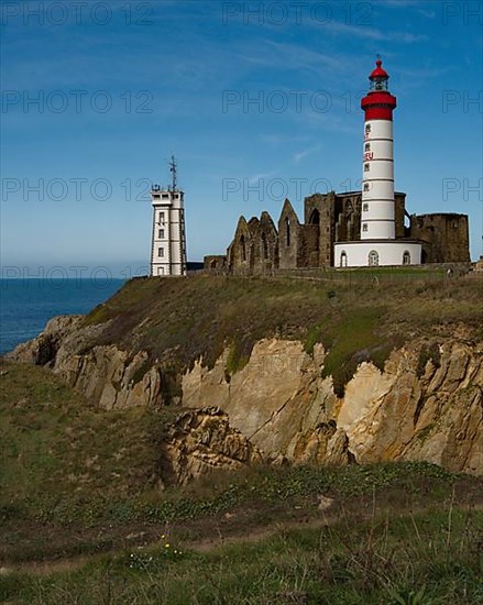 The lighthouse Phare de Saint-Mathieu with the chapel Notre Dame de Grace of Our Lady of Grace in the department of Finistere at the western tip of Brittany