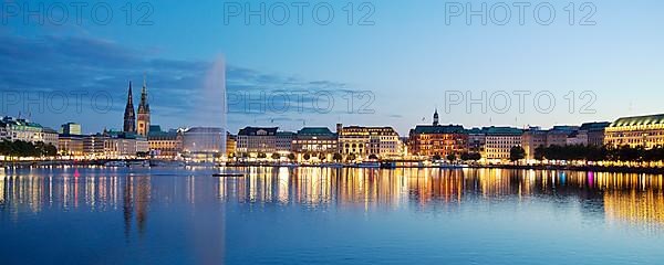 Inner Alster with Alsterfontaine and city skyline in the evening