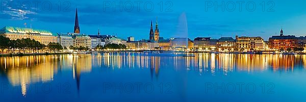 Inner Alster with Alsterfontaine and city skyline in the evening