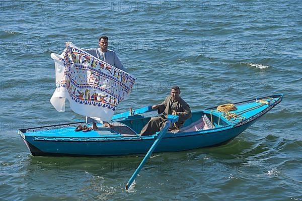 Flying traders on rowing boat near Esna