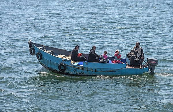 Family on a motorboat on the Nile near Esna