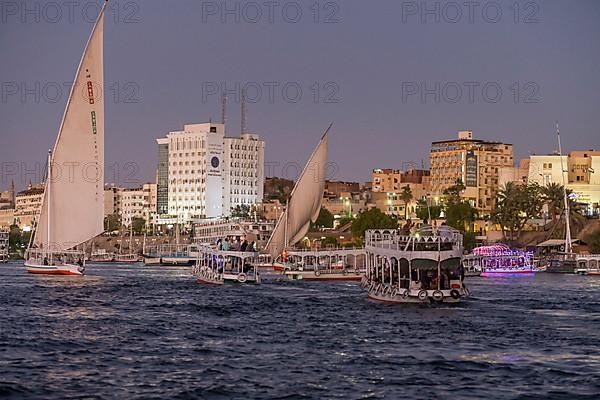 Sailing ships and excursion boats on the evening Nile at Aswan