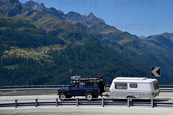 Off-road vehicle with caravan Gotthard Pass