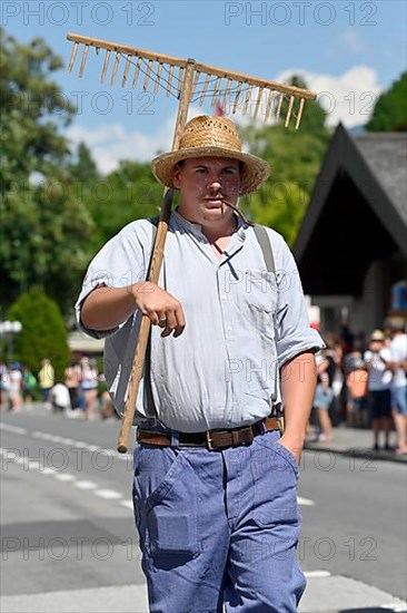 Parade man with hay rake