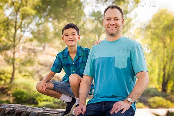 Outdoor portrait of biracial chinese and caucasian father and son