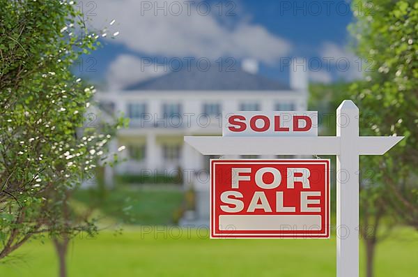 Sold for sale real estate sign in front of property