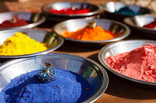 India symbol. Colored colorful powder kumkum in bowls on Indian bazaar for Holi and other festivals celebration
